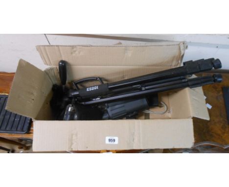 A box containing a Ricoh digital camera, a tripod, binoculars, etc.