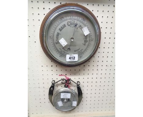 A vintage oak framed wall barometer with printed dial marked for W. Greenwood &amp; Sons, with aneroid works - glass cracked 