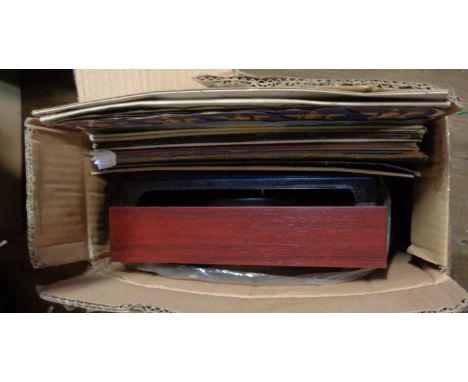 A record player and a brown case containing a selection of LP records