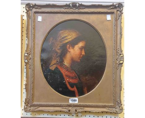 A gilt framed and oval slipped late 19th Century oil on canvas profile portrait of an Eastern European young woman wearing a 