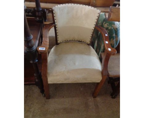 A 20th Century oak show frame elbow chair with tapestry upholstery and overstuffed seat, set on square front legs