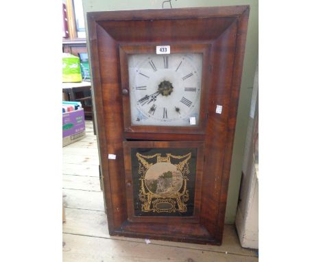 An early 20th Century American walnut cased wall clock with decorative glazed panel door and twin weight driven gong striking