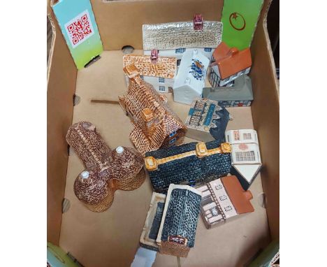 A box containing a quantity of ceramic model houses including Heritage, Wade, etc.