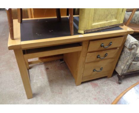 A 1.3m modern light oak single pedestal desk with inset writing surface and three graduated pedestal drawers, set on block fe