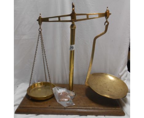 A set of old brass balance scales set on wooden base - sold with a quantity of weights