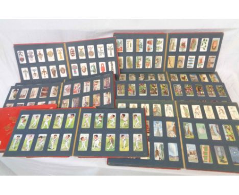 Eleven vintage 'Wills's Cigarette Card Albums' containing collections of mainly John Player and Wills's sets and parts sets o