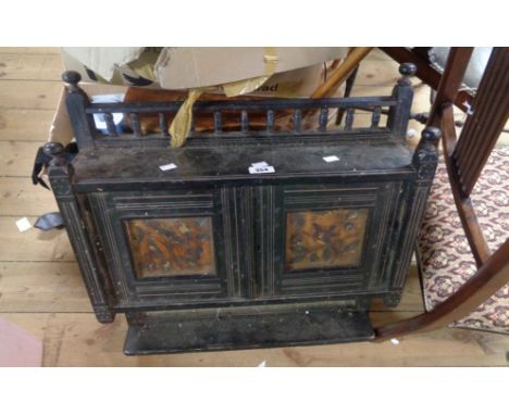 A 57cm late 19th Century Aesthetic Movement ebonised wood wall hanging shelf unit enclosed by a pair of painted panel doors