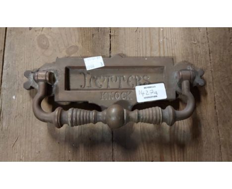An antique brass letter box with door knocker