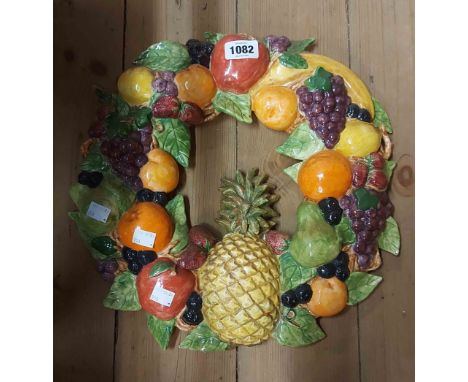 A large ceramic fruit garland wall mask with colourful painted decoration
