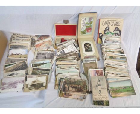 A box containing a collection of early 20th Century and other postcards including topographic, named views, greetings, posed 