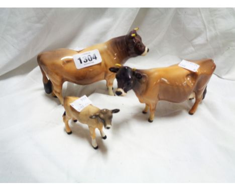 A Beswick pottery Jersey cattle family comprising bull, cow and calf