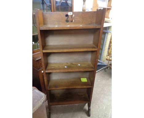 A 59cm Arts &amp; Crafts oak four shelf open bookcase with pierced decoration to top, set on shaped standard ends