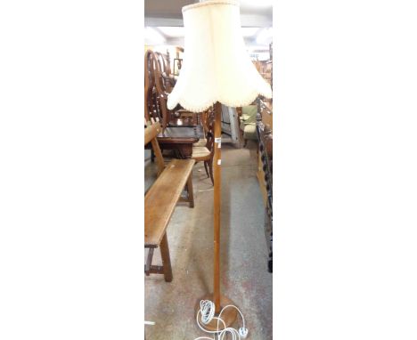 A vintage stained wood standard lamp, set on circular base - with shade