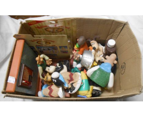 A box containing a quantity of Wallace and Gromet memorabilia including clock, figures, etc.