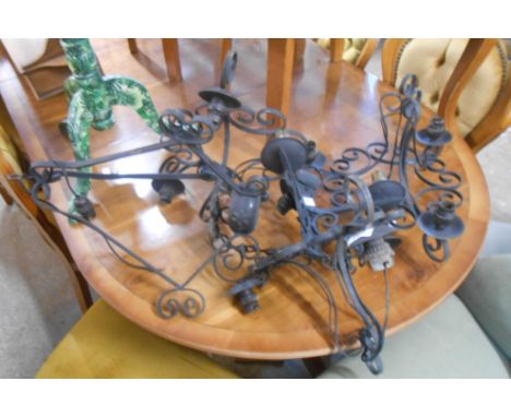 Four vintage wrought iron hanging lights with electrical fittings - sold with a similar wall sconce