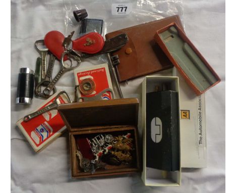 A bag containing a quantity of collectable items including vintage ballpoint pens, small wooden box containing military badge