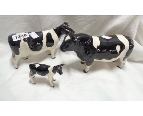 A Beswick pottery Friesian cattle family comprising bull, cow and calf