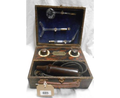 A vintage Roger's Vitalator with Bakelite body and glass attachments set in faux snakeskin wrapped fibreboard case