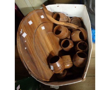 A carved wood Lazy Susan punch bowl set with wooden goblets and ladle