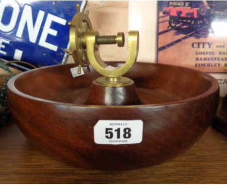 A turned hardwood bowl with central brass ship's wheel pattern nutcracker - by H.C. Crutchley of Alderburgh