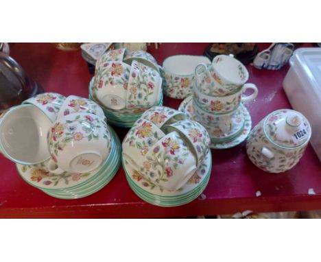 A quantity of Minton bone china teaware decorated in the Haddon Hall pattern including cups and saucers, plates, milk jug, su