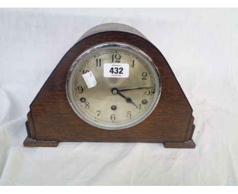 A vintage oak cased mantel clock with Garrard eight day chiming movement