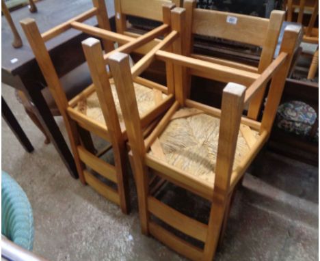A set of four modern light oak ladder back dining chairs with woven seat panels