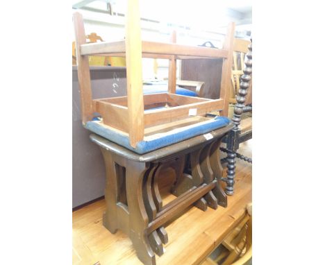 An Ercol dark elm nest of three tea tables - sold with an upholstered stool
