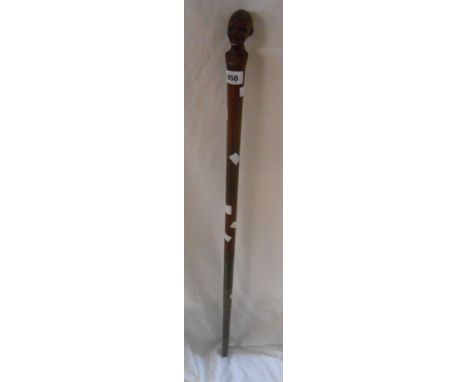 A vintage African wooden walking stick with carved man's head finial and specimen wood shaft