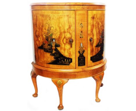 A 76cm 20th Century mixed wood bow front chinoiserie decorated cabinet with glass shelf enclosed by a pair of doors, set on c