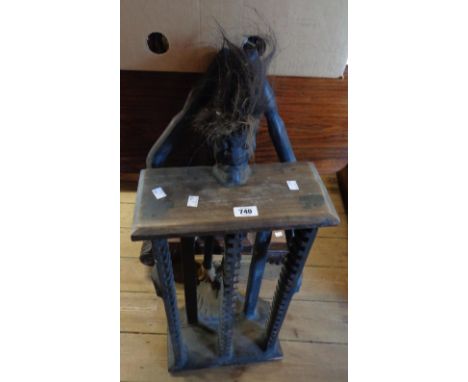 A carved wood CD rack with African tribal figure