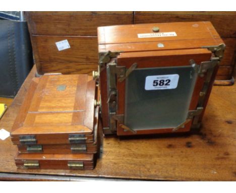 An antique camera marked 'The 1895 Instantograph Patent' with original photographer's hood