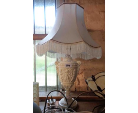 A decorative vintage plaster lamp, depicting cavorting putti - sold with shade