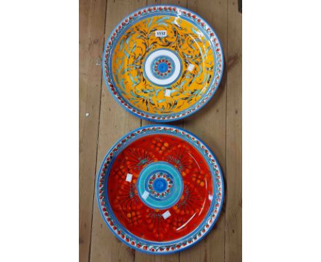 Two large modern Spanish ceramic wall chargers, each decorated in vibrant colours