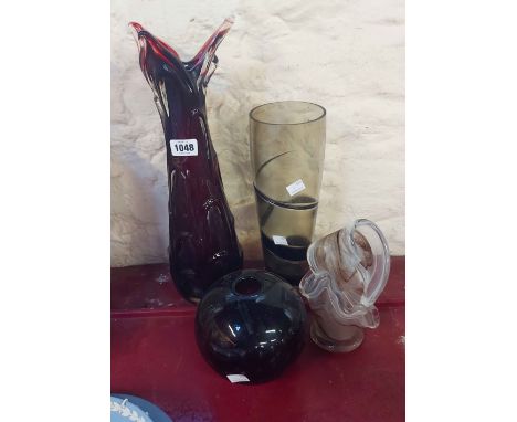 Four pieces of vintage art glass comprising a large ruby glass vase with clear cased knobbly decoration, a ribbon trailed smo