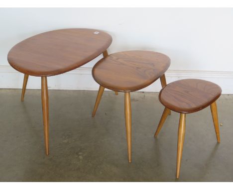 An Ercol pebble nest of three tables - 66cm x 44cm x 40cm