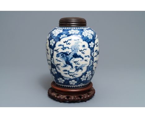 A Chinese blue and white Kangxi-style jar with Buddhist lions, 19th C. H.: 31,5 (the jar)H.: 37 cm (the lidded jar on stand) 