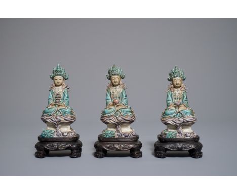 Three Chinese enamel on biscuit figures of Buddha, 19th C. H.: 15 cm (each figure incl. base) H.: 12 cm (each figure)Ê Condit
