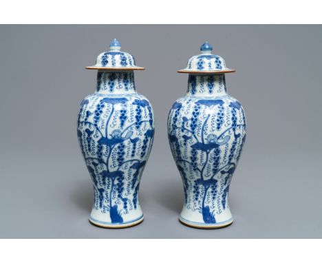 A pair of Chinese blue and white vases and covers with grapes, Kangxi H.: 28 cmÊ Condition: (UV-checked)- One cover in excell