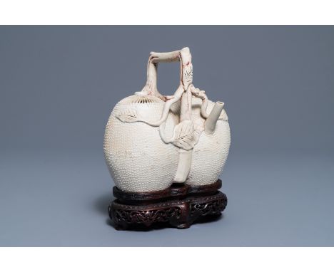 A Chinese biscuit 'conjoined peach' teapot and cover, Kangxi/Yongzheng H.: 19 cm---------Please request condition reports by 