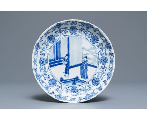 A Chinese blue and white moulded plate with figures on a terrace, Kangxi mark and of the period Dia.: 20 cm---------Please re