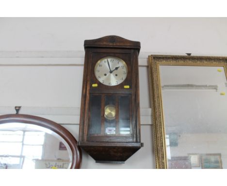 An oak cased two hole wall clock 