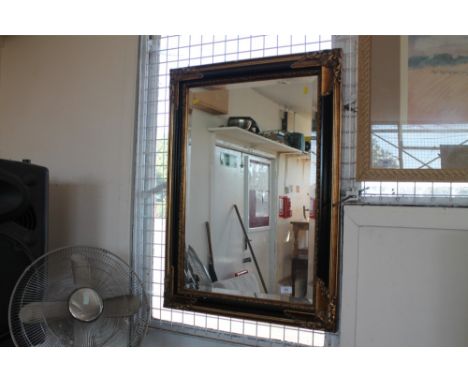 A gilt bevel edged oblong wall mirror 