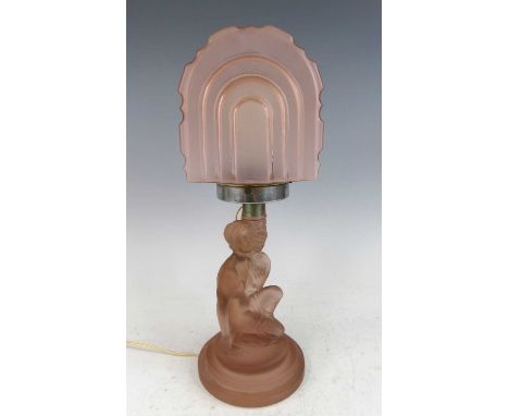 An Art Deco moulded and frosted peach glass table lamp, the shade of arched and stepped form, with chrome fitting, the base c