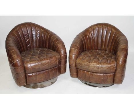 A pair of contemporary buttoned tan leather tub fan-backed swivel armchairs, in the Art Deco taste, raised on flattened circu