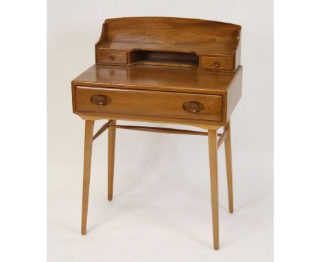 A 1960s Ercol light elm desk, model No.437, with raised twin drawer and part-open superstructure, over single frieze drawer t