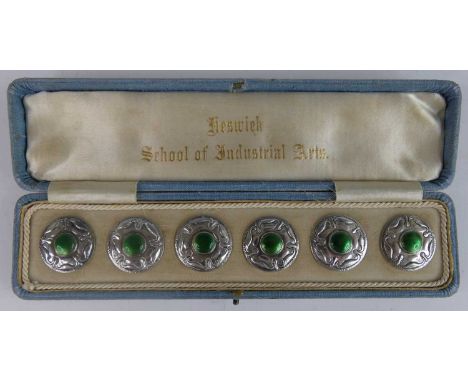 A cased set of six Keswick School of Industrial Arts white metal buttons, each with a central lime green inset cabochon, of s