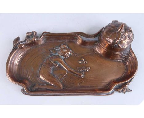 An Art Nouveau copper inkstand, of sinuous stylised form with floral detail and central kneeling maiden, the hinged compartme