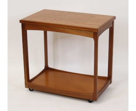 A 1970s teak two-tier fold-over tea trolley, having a swivel action, raised on roller castors, height 67.5cm, width 71cm, dep