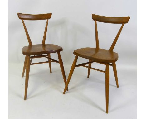 A pair of 1960s Ercol blond elm bar back school chairs, each on turned slightly tapering supports, each with patent back stam